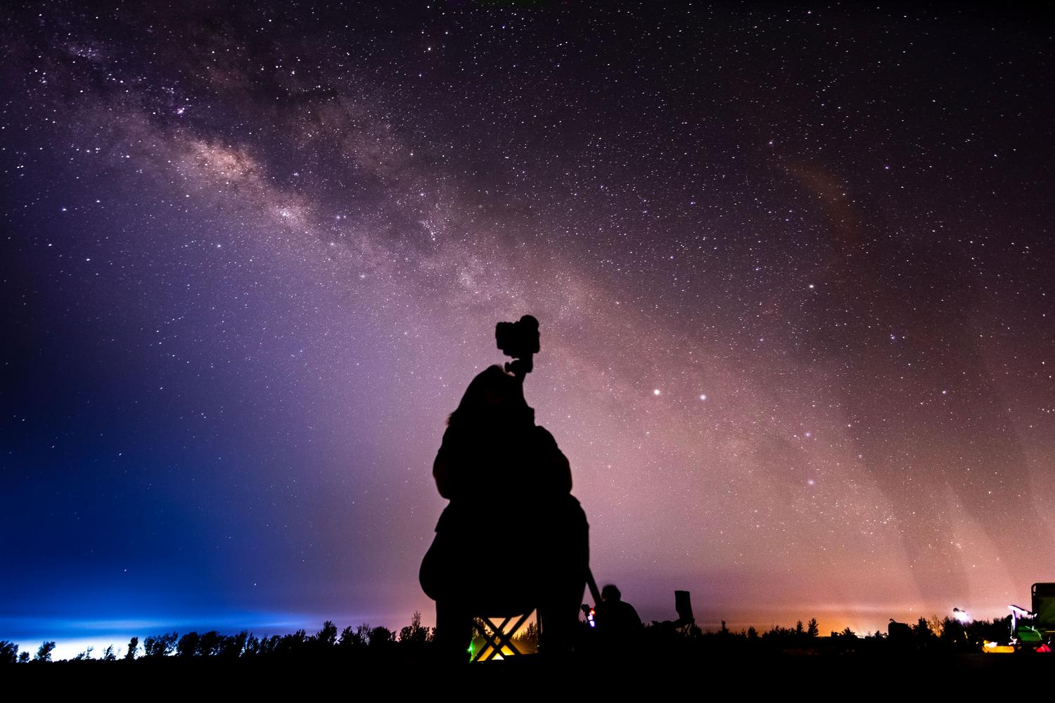 Fotogrāfs, kas naktī iemūžina Piena ceļu, lieliski piemērots astronomiskai plānošanai Fotogrāfs, kas naktī iemūžina Piena ceļu, lieliski piemērots astronomiskai plānošanai